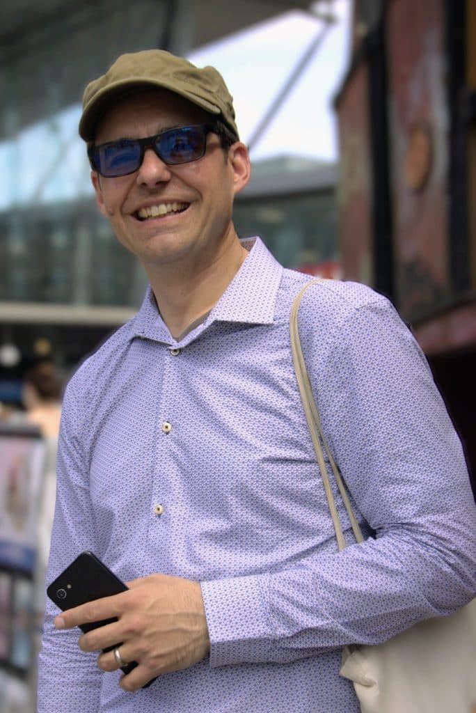 Photo of Dan, the Owner of Clarity, smiling outside in the sunshine meeting people. 15 years of research and qualitative interviewing experience.