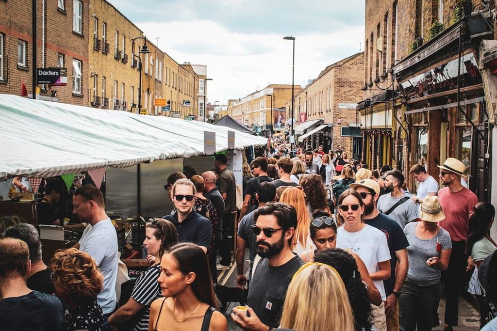 A photo of a crowded and sunny Broadway Market, near London Fields in Hackney. This is one of the most popular street markets in the Borough.