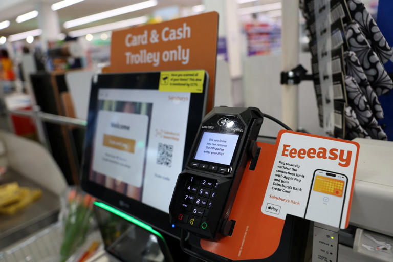 A close up image of a Sainsburys self-service till with a touchscreen and payment machine.